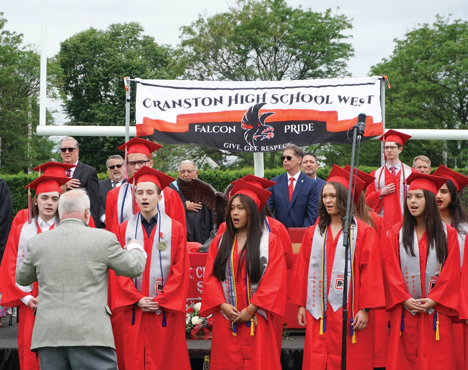 TOGETHER IN SONG: Cranston West Senior Choir members lead the crowd in singing the national anthem prior to
Saturday’s ceremony